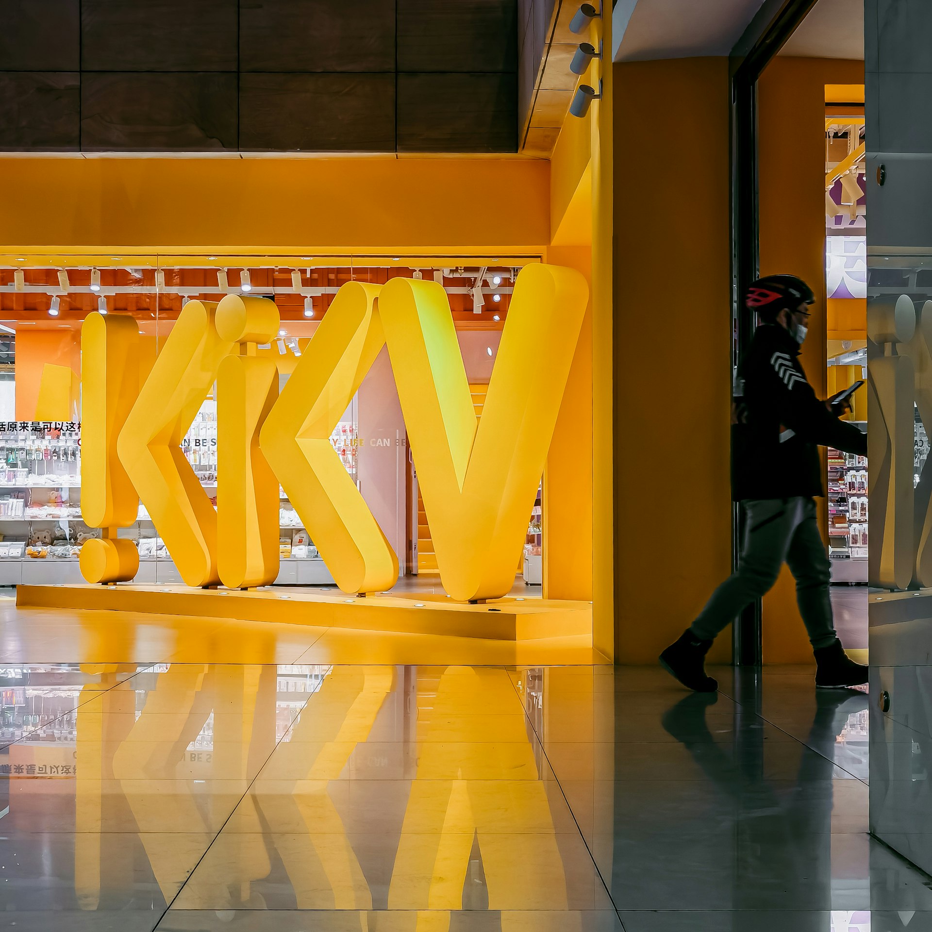 people walking on yellow and white floor tiles